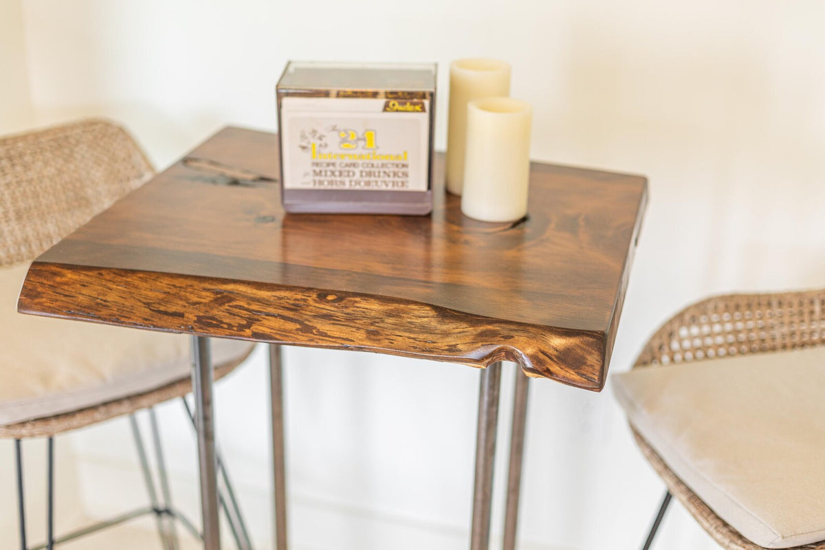 May include: A wooden table with a live edge top and metal legs. Two candles are on the table, and a box with the text "Lemonwood" is in the background.