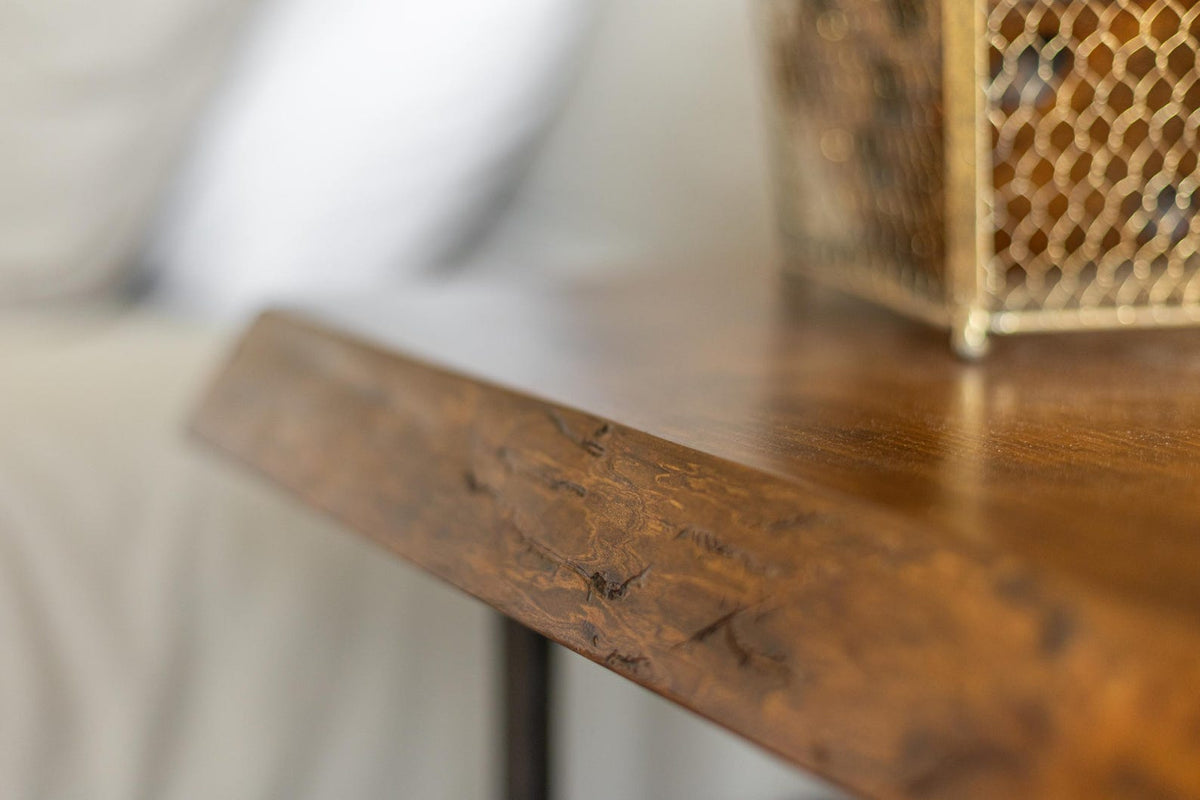 May include: Close-up of a dark brown wooden table top with a natural wood grain pattern. The table top is smooth and polished, with a slight sheen.